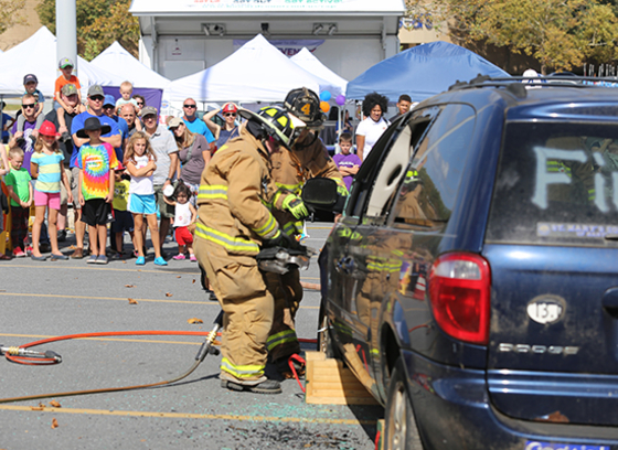 Firefighters use rescue tools on vehicle during demonstration