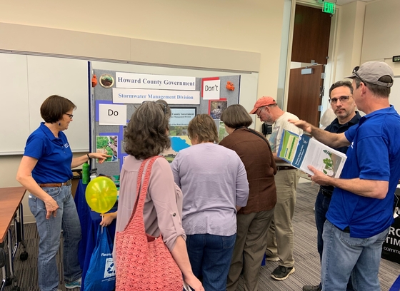 In this color photo, people gather around an informational booth at GreenFest.
