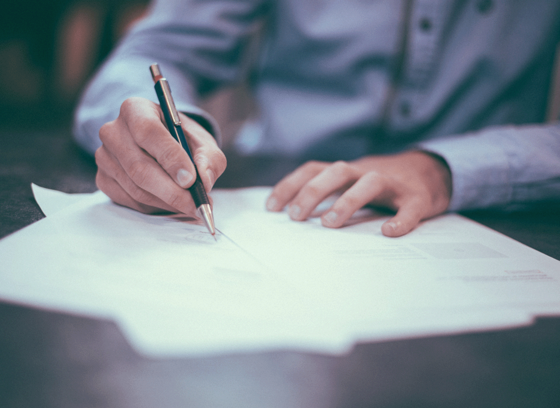 A person writing on a piece of paper