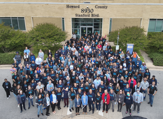 Photo of HCHD staff taken by drone standing outside Ascend One building