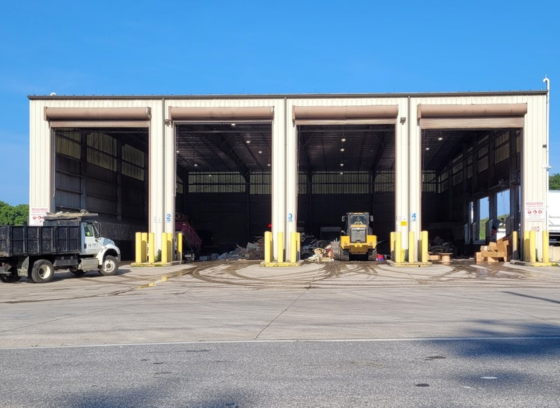 truck pulling into transfer station bay to unload commercial waste