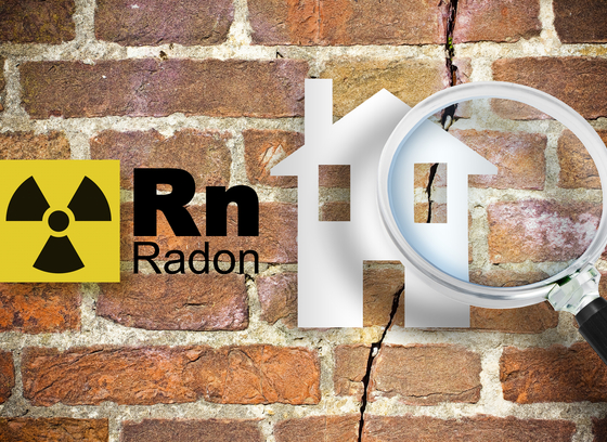 Yellow and Black radiation symbol, Rn periodic element abbreviation for radon, magnifying glass over house graphic, all on brick background