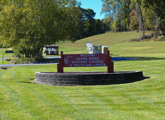 welcome sign in grass at the alpha ridge landfill 
