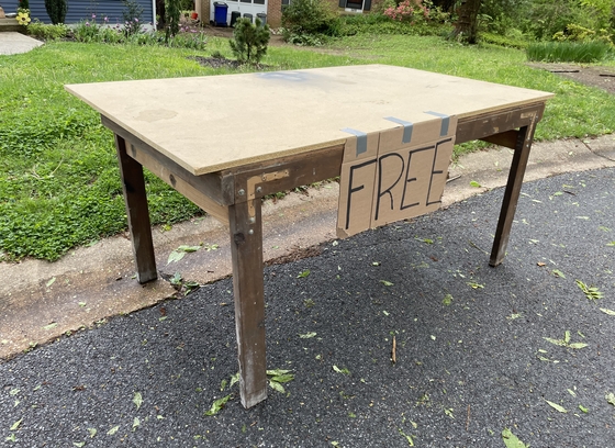 table placed at the curb with a free size taped to it