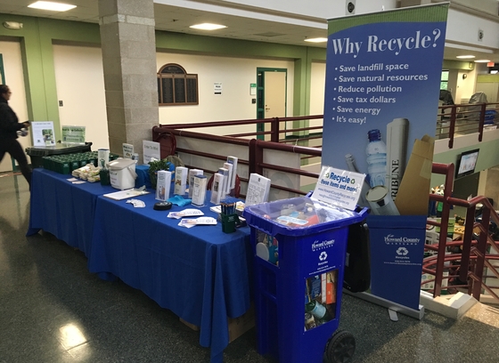 table with recycling literature and giveaways located at public event