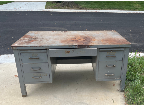 rusted metal table placed at curb for collection